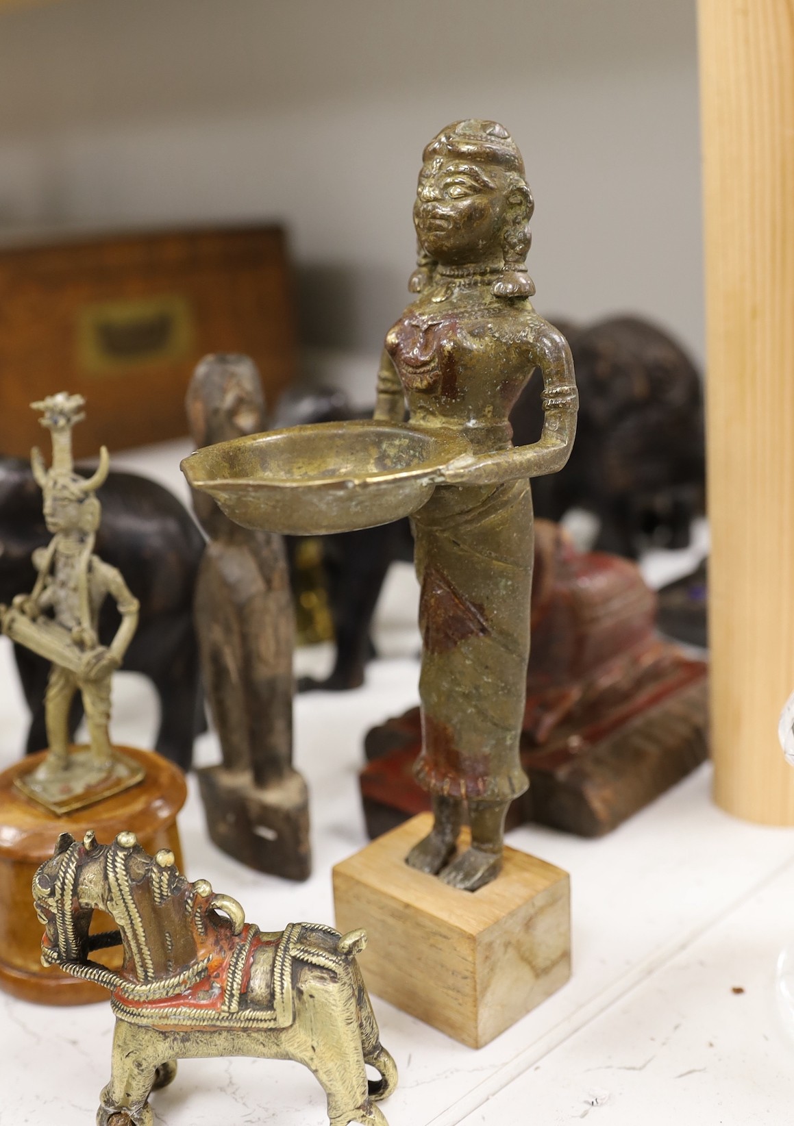 A quantity of Indian carvings and cast brass figures, tallest 20cm